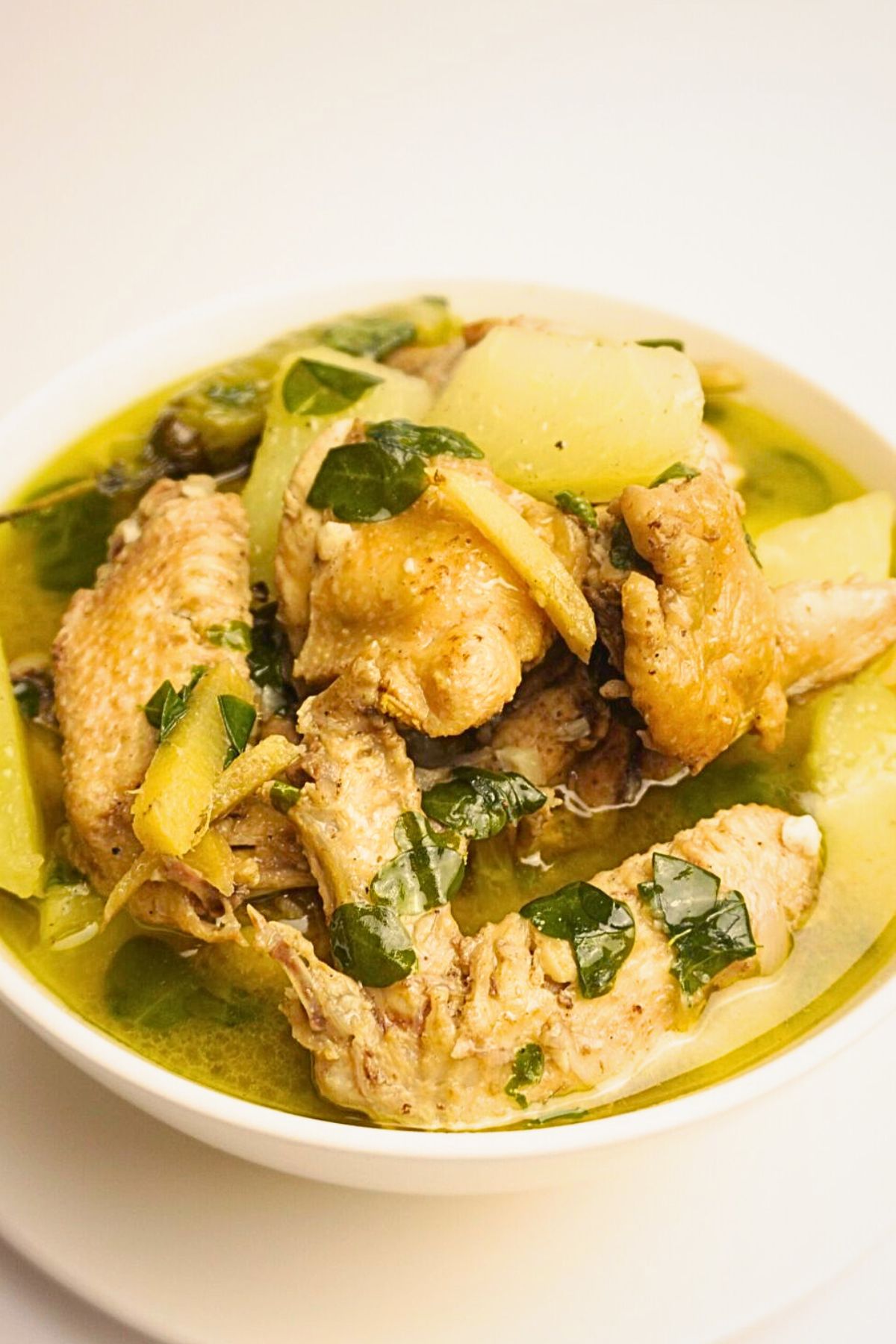 Comforting tinolang manok in a white bowl.