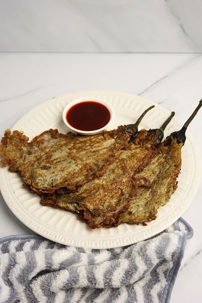 Tortang talong with ketchup dip on the side.