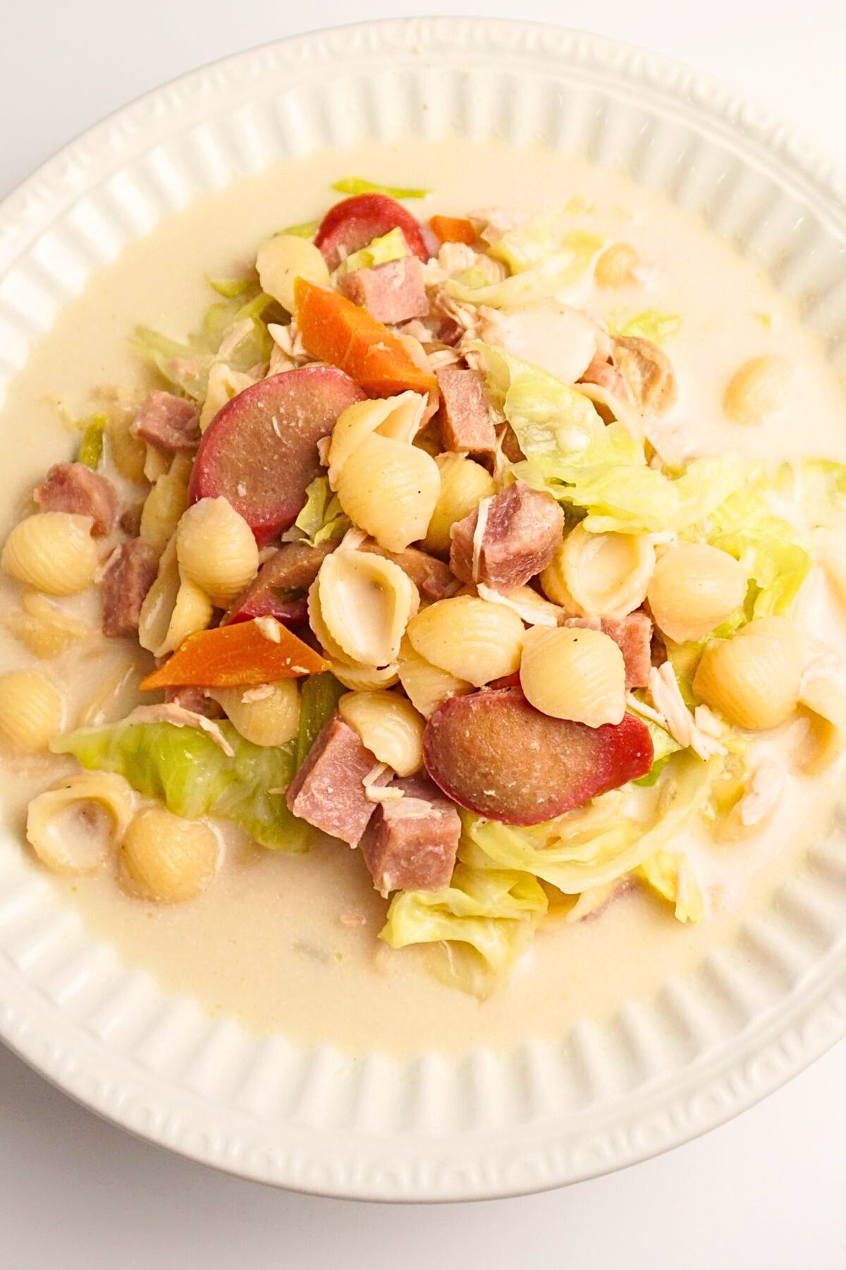 A serving of chicken sopas in a white plate.