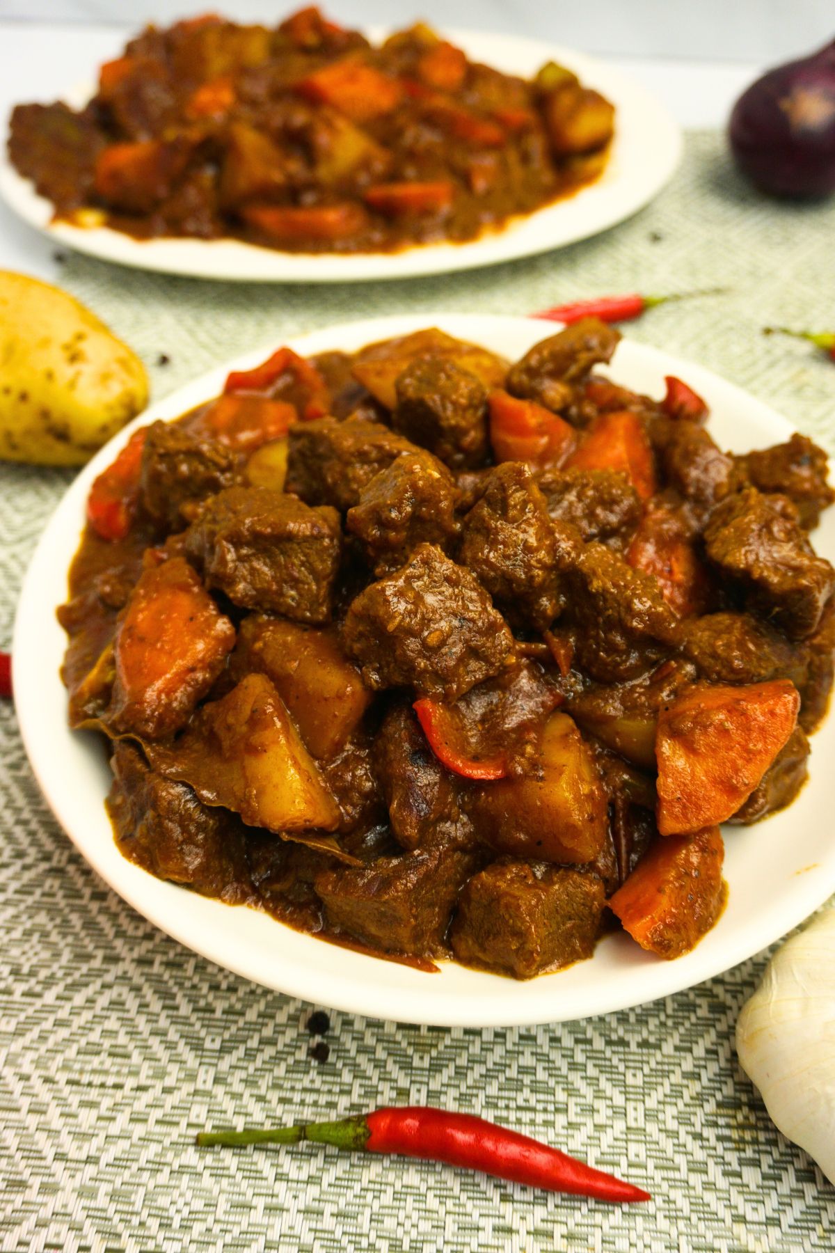 Spicy beef caldereta in thick tomato sauce with carrots, potatoes and bell peppers.