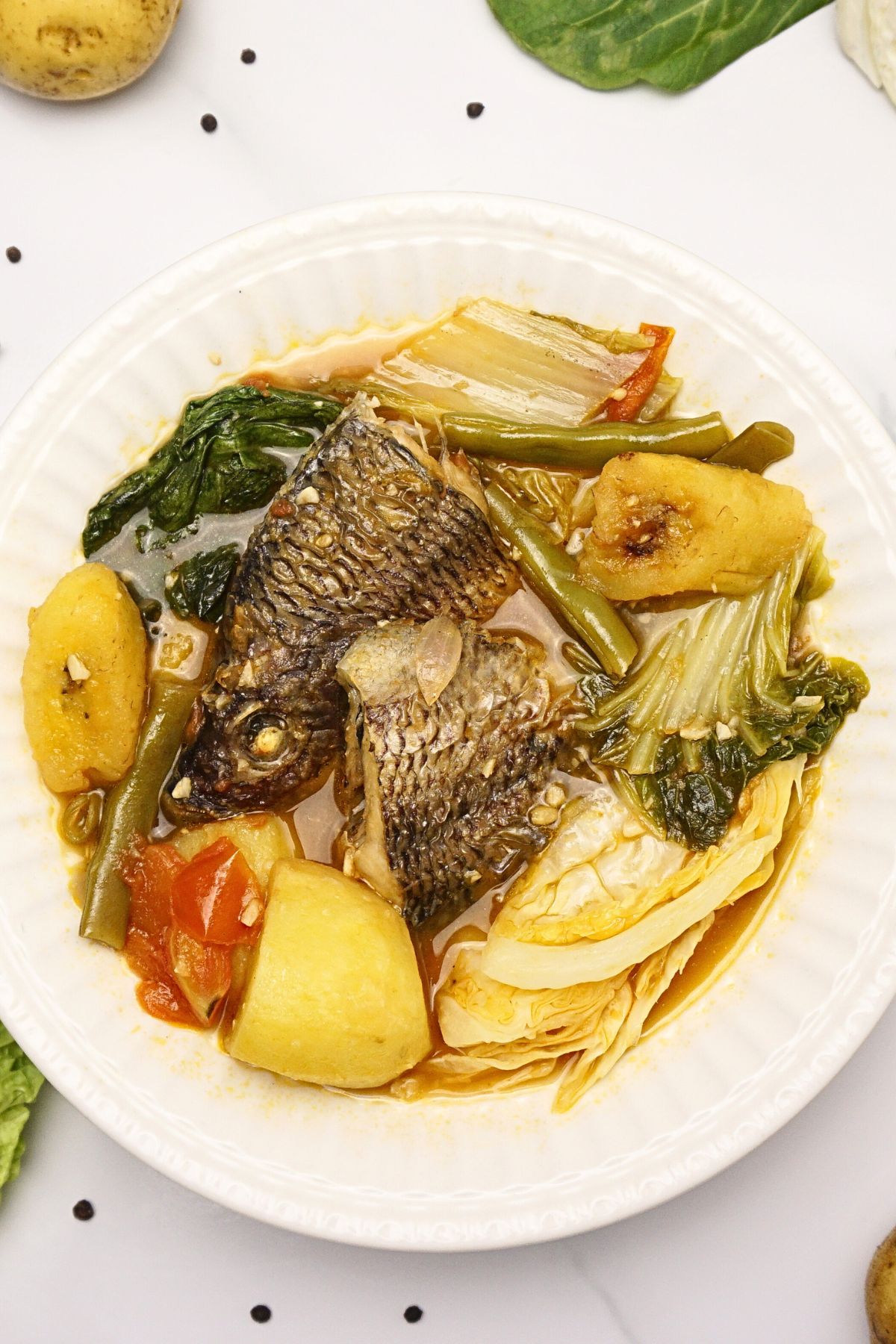 Tilapia with plantain, cabbage and potatoes.