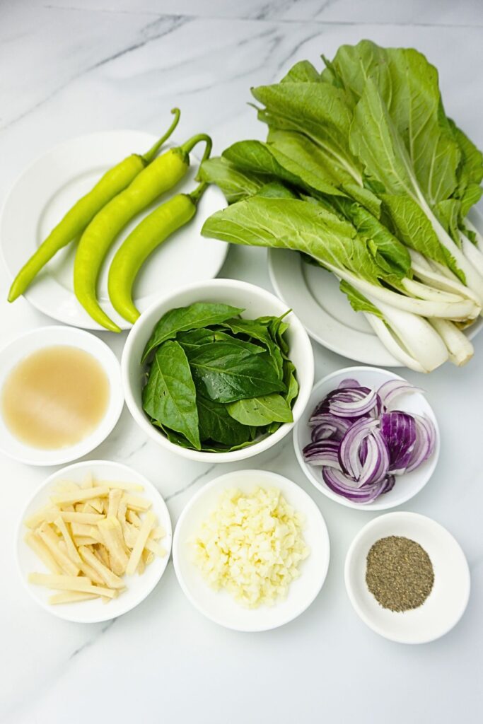 Batchoy kapampangan ingredients. Pechay, green chilies, fish sauce, chili leaves, onion, garlic, ginger and black pepper.