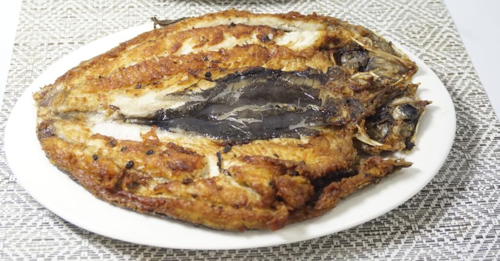 Fried daing na bangus in a plate.