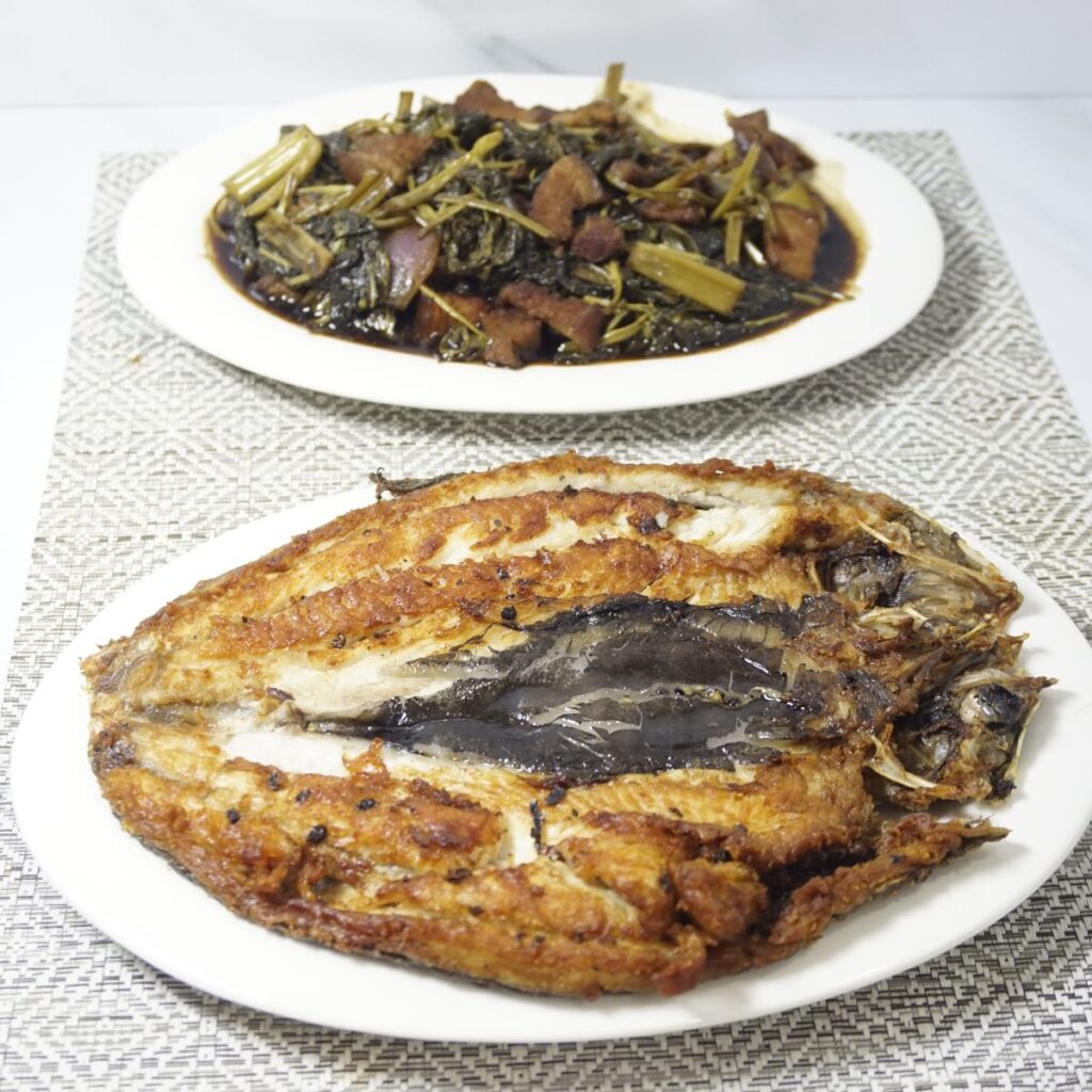 Crispy fried bangus daing served with adobong kangkong.